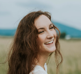 a smiling girl with curly hair